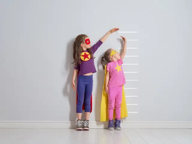 children measuring their height
